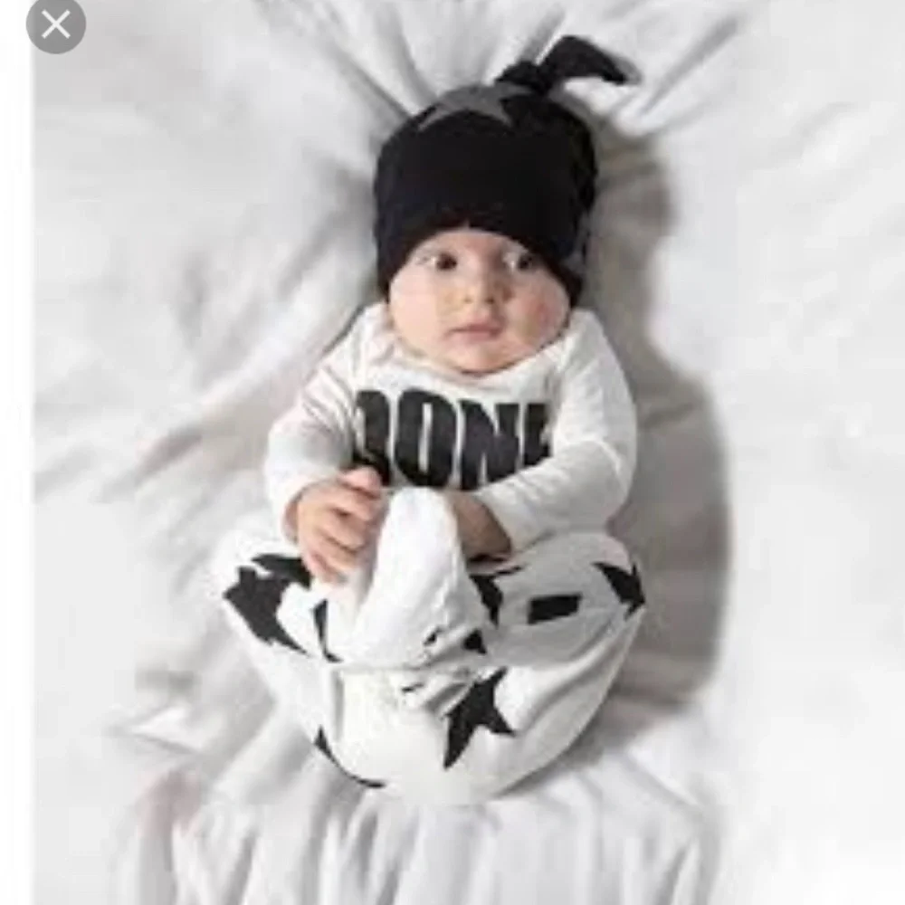 Baby Onesie with Black Star Pattern by boutique brand Nununu